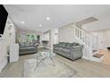 Bright living room with hardwood floors, neutral paint, large windows, recessed lighting, and staircase to second floor at 5242 Mccarter Sta, Stone Mountain, GA 30088