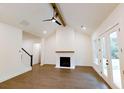 Spacious living room with a fireplace, vaulted ceiling, ceiling fan, and hardwood floors at 6525 Rhett Run, Cumming, GA 30028