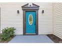 Close-up of a stylish blue front door with decorative trim and modern exterior lighting at 1841 Surrey Hill Cir, Lawrenceville, GA 30044