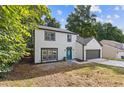 Charming two-story home with a well-maintained front yard, a blue front door, and an attached garage at 1841 Surrey Hill Cir, Lawrenceville, GA 30044