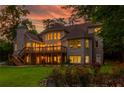Expansive backyard featuring a wooden deck, lush greenery, and lovely rose bushes at 1865 Mason Mill Rd, Decatur, GA 30033