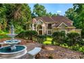 Traditional-style home with a water fountain and landscaped yard, perfect for enjoying the outdoors at 1865 Mason Mill Rd, Decatur, GA 30033