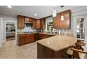 Well-lit kitchen with granite countertops, wood cabinets, and stainless steel appliances at 3912 Edenton Ne Ct, Brookhaven, GA 30319