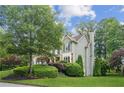 Beautifully landscaped home with green lawn and mature trees, offering a serene and inviting exterior at 4275 Green Summers Dr, Cumming, GA 30028