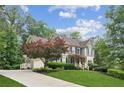 Attractive home showcasing a well-manicured lawn and a long driveway leading to a side-entry garage at 4275 Green Summers Dr, Cumming, GA 30028