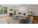 Bright living room features hardwood floors, neutral paint, and stylish furniture at 111 Abingdon Way, Sandy Springs, GA 30328