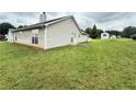 Spacious backyard offering ample green space with a concrete patio at 2658 Deann Dr, Ellenwood, GA 30294