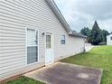View of home exterior showing back door leading to concrete patio at 2658 Deann Dr, Ellenwood, GA 30294