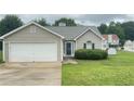 Inviting single-story house with a two-car garage and well-maintained front yard at 2658 Deann Dr, Ellenwood, GA 30294