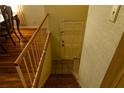 Looking down wooden stairs with off-white textured wallpaper on the right wall at 2831 Carolyn Se Dr, Smyrna, GA 30080