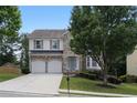 Charming two-story home featuring a stone facade, well-manicured lawn, and a two-car garage at 1722 Preserve Creek Way, Loganville, GA 30052