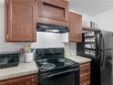 Close up shot of the kitchen featuring modern appliances, and wood cabinets at 2567 Hancock Rd, Social Circle, GA 30025