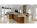 Open concept kitchen with granite countertops, breakfast bar, and hardwood floors at 4171 Lantern Hill Dr, Dacula, GA 30019