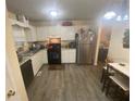 Functional kitchen with white cabinets, stainless steel appliances, and modern flooring at 8951 Stonebridge Blvd, Douglasville, GA 30134