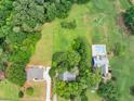 An aerial view of the home's backyard, highlighting a serene pool area perfect for relaxation and outdoor enjoyment at 4444 Cannon Sw Rd, Loganville, GA 30052