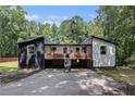 View of the home's exterior showcasing the black and white color scheme and front entry at 140 Indian Lake Dr, Hiram, GA 30141