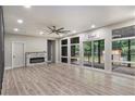 Spacious living room with hardwood floors, recessed lighting, fireplace, and screened-in porch at 140 Indian Lake Dr, Hiram, GA 30141