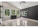 Bright living room with fireplace, high ceilings, multiple windows, and modern finishes at 140 Indian Lake Dr, Hiram, GA 30141