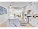Modern kitchen with white cabinetry, a marble island and stainless steel appliances perfect for cooking and entertaining at 1456 S Gordon Sw St, Atlanta, GA 30310