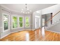 Open-concept living space featuring hardwood floors, large windows, and staircase access at 4016 Upland Trce, Marietta, GA 30066