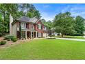 Beautifully landscaped lawn and two-story brick home, perfect for a Gathering at 4401 Madison Woods Nw Dr, Marietta, GA 30064