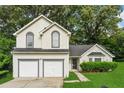 Charming two-story home with a two-car garage and beautifully landscaped front yard at 4464 Idlewood Park, Lithonia, GA 30038