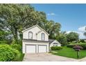 Lovely two-story home with two car garage, manicured lawn and mature trees at 4464 Idlewood Park, Lithonia, GA 30038