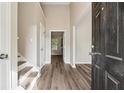 Inviting foyer with soaring ceiling, attractive flooring and staircase at 4464 Idlewood Park, Lithonia, GA 30038