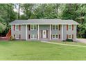 Charming home with a well-manicured lawn and beautiful, gray painted brick exterior at 1863 Rockford Ct, Riverdale, GA 30296