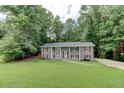 Charming home with a well-manicured lawn and beautiful, gray painted brick exterior at 1863 Rockford Ct, Riverdale, GA 30296