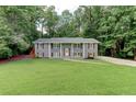 Charming home with a well-manicured lawn and beautiful, gray painted brick exterior at 1863 Rockford Ct, Riverdale, GA 30296