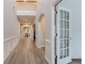 Bright entryway with beautiful hardwood floors, arched doorways, and a view to the dining room at 2940 Bentbill Xing, Cumming, GA 30041