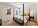 Cozy bedroom featuring a four-poster bed, soft carpet, and a bedside table with lamps at 4020 Emerald Glade Ct, Cumming, GA 30040