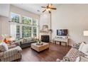 Bright living room boasts high ceilings, large windows, a fireplace, and stylish furniture arrangement at 4020 Emerald Glade Ct, Cumming, GA 30040