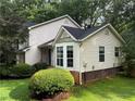 Rear exterior of a two-story home with vinyl siding and a neatly landscaped yard at 1035 Towne Manor Nw Ct, Kennesaw, GA 30144