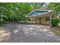 Side view of the house showing the long driveway, carport, and spacious backyard at 1729 Norden Rd, Riverdale, GA 30296