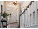 Bright entryway with hardwood floors, decorative lighting, and a staircase leading to the upper level at 338 Boundless Ln, Canton, GA 30114