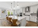 Modern kitchen with white cabinetry, stainless steel appliances, and a large center island with seating at 338 Boundless Ln, Canton, GA 30114