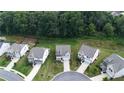Birds-eye view of well-maintained homes with manicured lawns and long driveways in a desirable neighborhood at 5090 Bellehurst Ln, Cumming, GA 30040