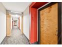 Apartment hallway with neutral colored walls, modern lighting fixtures and plush carpeting at 799 Hammond Dr # 325, Atlanta, GA 30328
