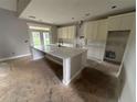 Spacious kitchen with a large marble island, modern cabinets, and a door to the outside at 99 Mountain Brook Dr, Cumming, GA 30041