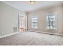 Bright, carpeted living room featuring neutral walls and natural light at 100 Hamilton Glen Ct, Fayetteville, GA 30215