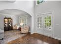 Inviting entryway features arched doorway, hardwood floors, and lots of natural light at 1045 River Pt, Suwanee, GA 30024