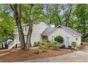 Inviting home exterior featuring mature trees, detailed landscaping, and a welcoming entrance at 2240 Six Branches Dr, Roswell, GA 30076