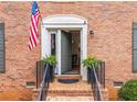 Close-up of a brick home's entrance, highlighting a welcoming door and manicured landscaping at 3131 Sumter Ct, Marietta, GA 30062
