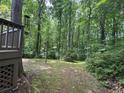 Lush backyard featuring mature trees and landscaping, creating a private and serene outdoor space at 4782 Donnegal Se Ct, Mableton, GA 30126