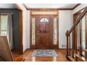 Elegant foyer with a decorative wood door, hardwood floors, and a staircase at 4782 Donnegal Se Ct, Mableton, GA 30126