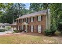 Inviting brick two-story home with a covered entrance and mature landscaping in a wooded setting at 4782 Donnegal Se Ct, Mableton, GA 30126