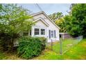 This home features a partially fenced yard with mature trees adding shade and privacy to the property at 8573 Campbellton St, Douglasville, GA 30134