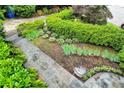 Manicured landscape featuring healthy green shrubs, pavers and decorative rock at 935 Cumberland Ne Rd, Atlanta, GA 30306